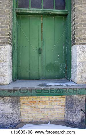 Painted green wooden door of industrial building, Winnipeg, Manitoba View Large Photo Image Stock Photo - Painted green wooden door of industrial building, Winnipeg, Manitoba. Fotosearch