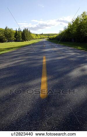 Stock Image - Paved highway, Cypress Hills Interprovincial Park, Saskatchewan, Canada. Fotosearch