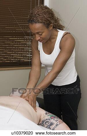 Stock Image - Person receiving massage therapy, British Columbia, Canada. Fotosearch
