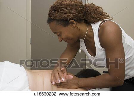Stock Image - Person receiving massage therapy, British Columbia, Canada. Fotosearch