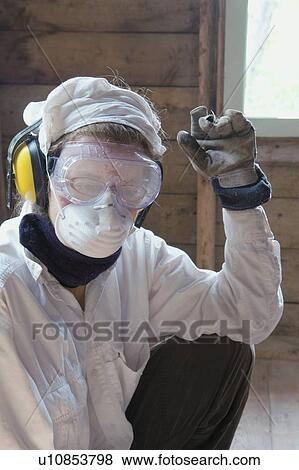 Stock Photo - Person with protective gear for renovations, Manitoba, Canada. Fotosearch