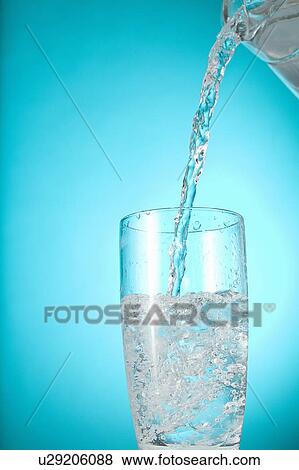 Pitcher of water pouring into clear glass View Large Photo Image Stock Photo - Pitcher of water pouring into clear glass. Fotosearch