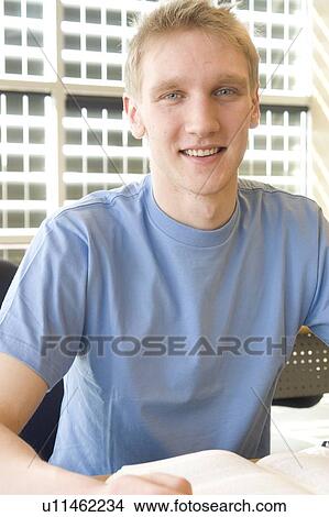 Portrait of male student in front of solar panelled windows, Winnipeg, Canada. View Large Photo Image Picture - Portrait of male student in front of solar panelled windows, Winnipeg, Canada.. Fotosearch