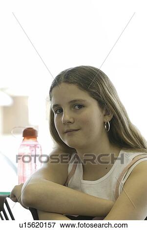 Stock Photo - Portrait of pre-teen girl, wearing shirt made with hemp fibre, with reusable water bottle, Canada, Manitoba, Brandon. Fotosearch