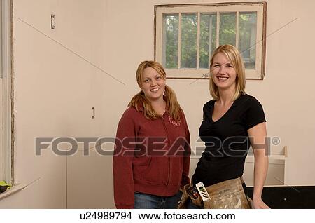 Picture - Portrait of two woman doing renovations. Fotosearch