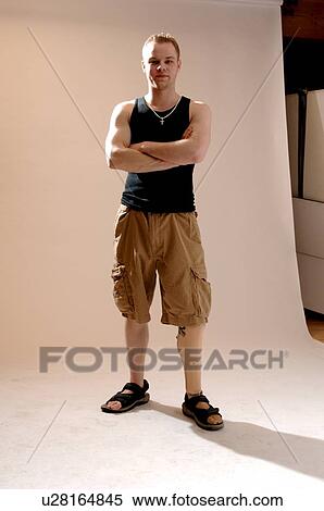 Portrait of young man (21 years of age) showing his prosthesis, having lost lower leg to cancer; Canada, Saskatchewan, Regina View Large Photo Image Stock Photography - Portrait of young man (21 years of age) showing his prosthesis, having lost lower leg to cancer; Canada, Saskatchewan, Regina. Fotosearch
