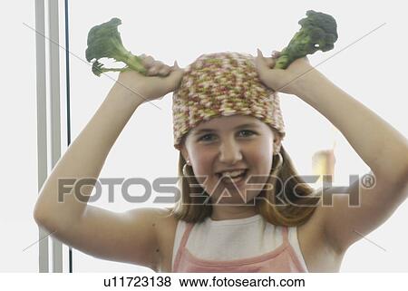 Pre-teen girl holding organic broccoli, wearing shirt made with hemp fibre, Canada, Manitoba, Brandon View Large Photo Image Stock Photo - Pre-teen girl holding organic broccoli, wearing shirt made with hemp fibre, Canada, Manitoba, Brandon. Fotosearch