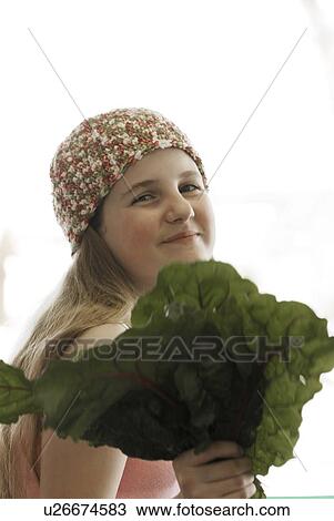 Pre-teen girl holding organic red chard, wearing shirt made with hemp fibre, Canada, Manitoba, Brandon View Large Photo Image Stock Image - Pre-teen girl holding organic red chard, wearing shirt made with hemp fibre, Canada, Manitoba, Brandon. Fotosearch