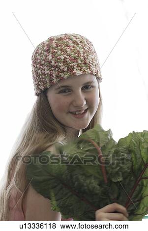Pre-teen girl holding organic red chard, wearing shirt made with hemp fibre, Canada, Manitoba, Brandon View Large Photo Image Stock Photo - Pre-teen girl holding organic red chard, wearing shirt made with hemp fibre, Canada, Manitoba, Brandon. Fotosearch