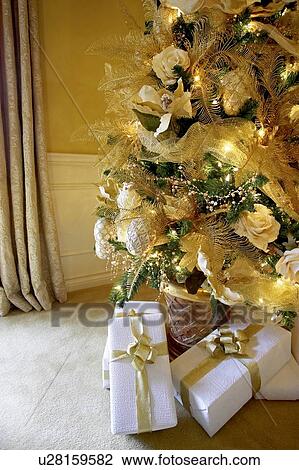 Stock Image - Presents under a Christmas tree, Canada, Ontario. Fotosearch