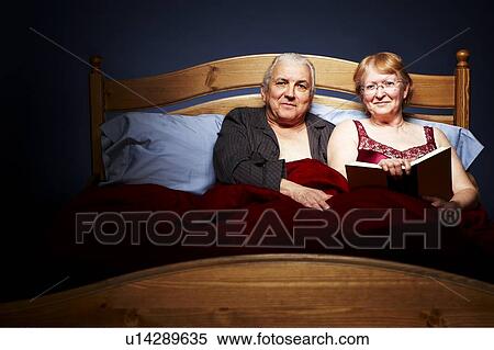 Senior Couple cuddling in bed View Large Photo Image Stock Photography - Senior Couple cuddling in bed. Fotosearch