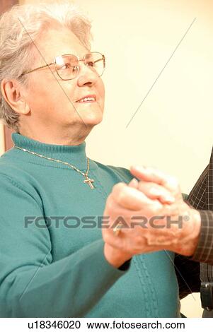 Stock Image - Senior Couple Dancing; Canada, Saskatchewan, Regina. Fotosearch