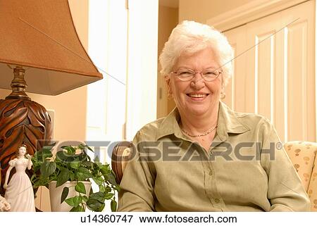 Stock Photo - Senior Woman in chair, Regina, Saskatchewan. Fotosearch