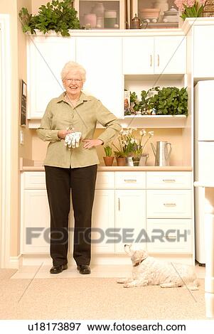 Senior Woman with plants; Canada, Saskatchewan, Regina View Large Photo Image Stock Photo - Senior Woman with plants; Canada, Saskatchewan, Regina. Fotosearch