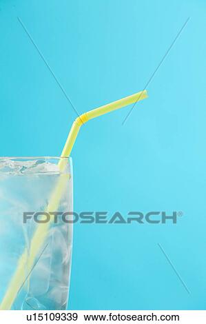 Stock Photo - Side portion of clear glass of water with yellow drinking straw. Fotosearch