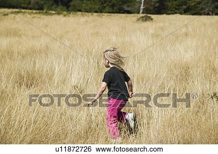 Sidney Spit Marine Park, BC, Canada. 5 year old playing in a grass field. View Large Photo Image Stock Photograph - Sidney Spit Marine Park, BC, Canada. 5 year old playing in a grass field.. Fotosearch