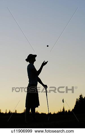 Stock Photo - Silhouette of young woman on organic golf course, Clear Lake Golf Course, Riding Mountain National Park, Manitoba, Canada. Fotosearch