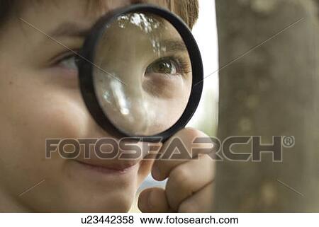 Six year old boy looking through magnifying glass, Winnipeg, Canada View Large Photo Image Stock Photo - Six year old boy looking through magnifying glass, Winnipeg, Canada. Fotosearch