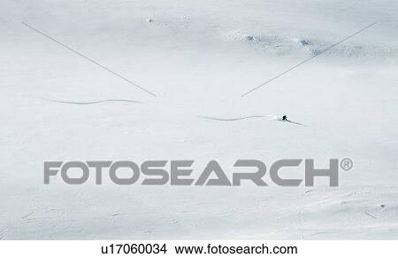 Skier dwarfed by mountain, British Columbia, Rogers Pass View Large Photo Image Picture - Skier dwarfed by mountain, British Columbia, Rogers Pass. Fotosearch