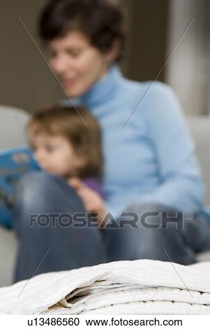 Stack of cloth diapers in foreground, behind mother and child reading on sofa, Winnipeg, Canada View Large Photo Image Stock Image - Stack of cloth diapers in foreground, behind mother and child reading on sofa, Winnipeg, Canada. Fotosearch