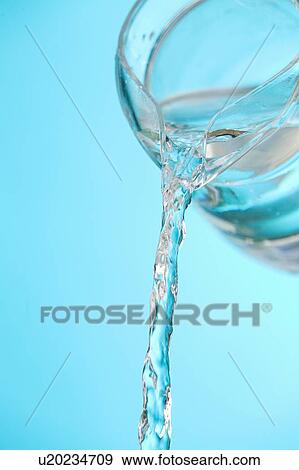 Stream of water being poured from a pitcher View Large Photo Image Stock Photo - Stream of water being poured from a pitcher. Fotosearch
