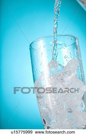 Stock Photo - Stream of water being poured into a clear glass. Fotosearch
