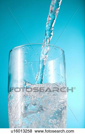 Stream of water being poured into a clear glass View Large Photo Image Stock Photo - Stream of water being poured into a clear glass. Fotosearch
