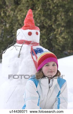 Thirteen year old girl kneeling beside snowman, Winnipeg, Canada View Large Photo Image Stock Image - Thirteen year old girl kneeling beside snowman, Winnipeg, Canada. Fotosearch