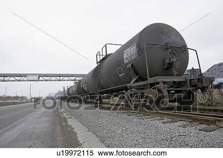 Train alongside empty road in industrial setting, Hamilton, Ontario. View Large Photo Image Stock Photography - Train alongside empty road in industrial setting, Hamilton, Ontario.. Fotosearch