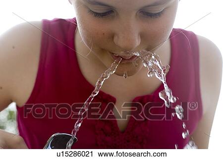 Twelve year old girl drinks from water fountain in park, Winnipeg, Canada View Large Photo Image Stock Image - Twelve year old girl drinks from water fountain in park, Winnipeg, Canada. Fotosearch