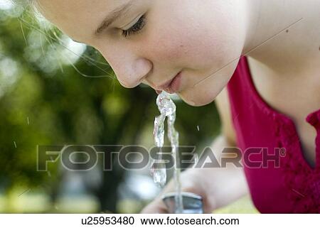 Twelve year old girl drinks from water fountain in park, Winnipeg, Canada View Large Photo Image Stock Image - Twelve year old girl drinks from water fountain in park, Winnipeg, Canada. Fotosearch
