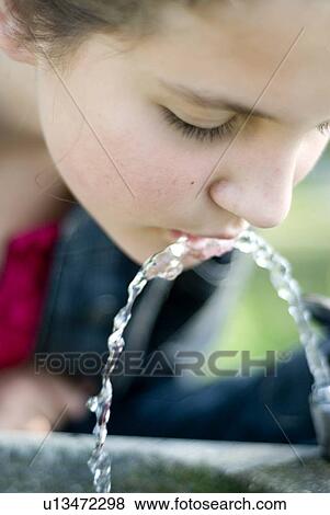 Twelve year old girl drinks from water fountain in park, Winnipeg, Canada View Large Photo Image Stock Photo - Twelve year old girl drinks from water fountain in park, Winnipeg, Canada. Fotosearch