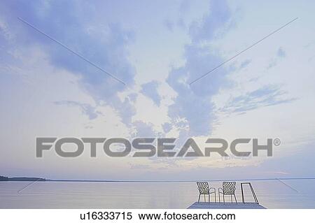 Two folding lawn chairs on dock at Clear Lake; Canada, Manitoba, Riding Mountain National Park View Large Photo Image Stock Photography - Two folding lawn chairs on dock at Clear Lake; Canada, Manitoba, Riding Mountain National Park. Fotosearch