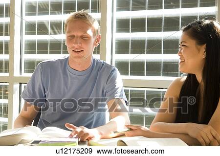 Two students seated, talking, in front of solar panelled windows, Winnipeg, Canada View Large Photo Image Stock Photo - Two students seated, talking, in front of solar panelled windows, Winnipeg, Canada. Fotosearch
