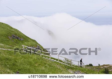 Stock Photo - View of hiker at Signal Hill, St John's, Newfoundland, Canada. Fotosearch