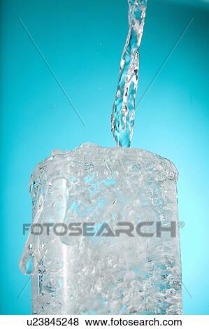 Water pouring into overflowing glass View Large Photo Image Stock Photo - Water pouring into overflowing glass. Fotosearch