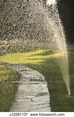 Stock Photo - Watering the lawns in Banff. Fotosearch