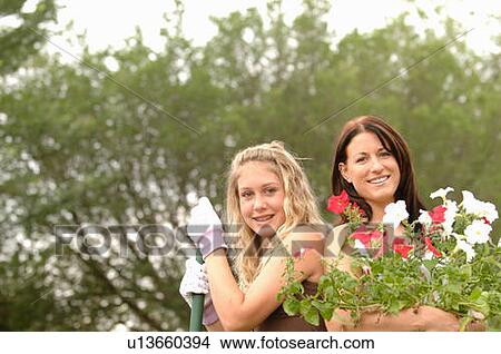Picture - Woman and girl with rake and flowers, Regina, Saskatchewan. Fotosearch