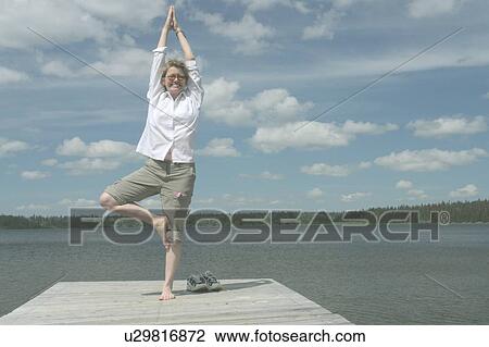 Woman in yoga pose on dock, Clear Lake; Canada, Manitoba, Riding Mountain National Park View Large Photo Image Stock Image - Woman in yoga pose on dock, Clear Lake; Canada, Manitoba, Riding Mountain National Park. Fotosearch