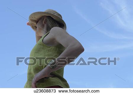 Stock Image - Woman looking out over Lake; Canada, Manitoba, Riding Mountain National Park. Fotosearch