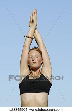 Picture - Woman stretching arms upward, Grayling Lake, Riding Mountain National Park, Manitoba, Canada. Fotosearch