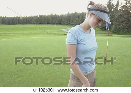 Stock Image - Woman wearing hemp shirt on organic golf course, Clear Lake Golf Course, Riding Mountain National Park, Manitoba, Canada. Fotosearch