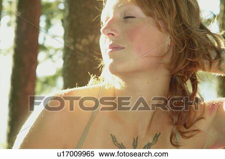 Woman with eyes closed in grove of trees, Riding Mountain National Park, Manitoba, Canada View Large Photo Image Stock Photography - Woman with eyes closed in grove of trees, Riding Mountain National Park, Manitoba, Canada. Fotosearch