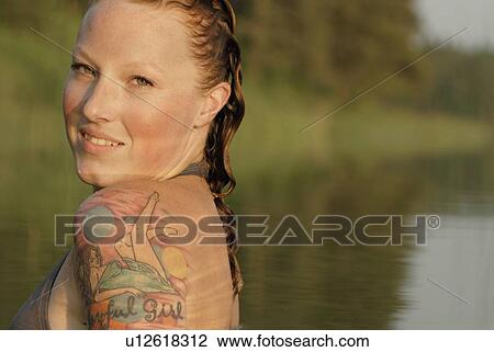 Woman with wet hair and tattoos in lake, Lake Katherine, Riding Mountain National Park, Manitoba, Canada View Large Photo Image Stock Image - Woman with wet hair and tattoos in lake, Lake Katherine, Riding Mountain National Park, Manitoba, Canada. Fotosearch