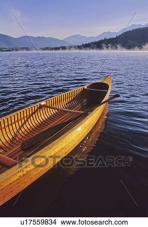 Picture - Wood canoe with paddles on Alta Lake, Whistler, in early morning. Fotosearch