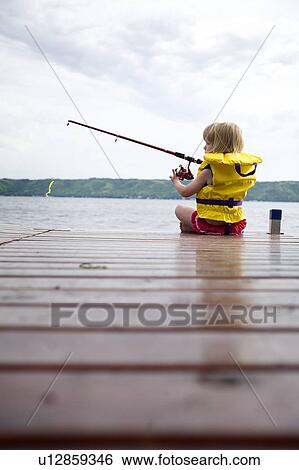 Young girl wearing life preserver fishing off the end of dock at Echo Lake, Saskatchewan, Canada View Large Photo Image Stock Photograph - Young girl wearing life preserver fishing off the end of dock at Echo Lake, Saskatchewan, Canada. Fotosearch