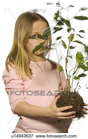 Stock Photo - Young girl with tree sapling. Fotosearch