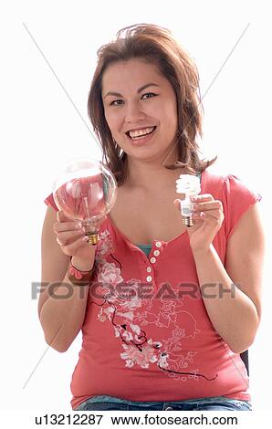 Stock Photo - Young girl w/Light bulb, Regina, Saskatchewan. Fotosearch