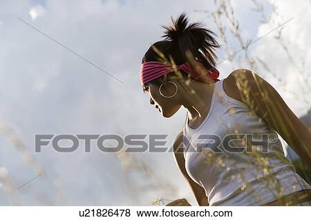 Stock Photo - Young woman (19) in alpine meadow, Haute Savoie, France. Fotosearch