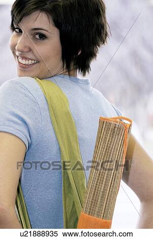 Young woman carrying bamboo mat and cloth shopping bag made with hemp fibres, Canada, Manitoba, Brandon View Large Photo Image Stock Photography - Young woman carrying bamboo mat and cloth shopping bag made with hemp fibres, Canada, Manitoba, Brandon. Fotosearch